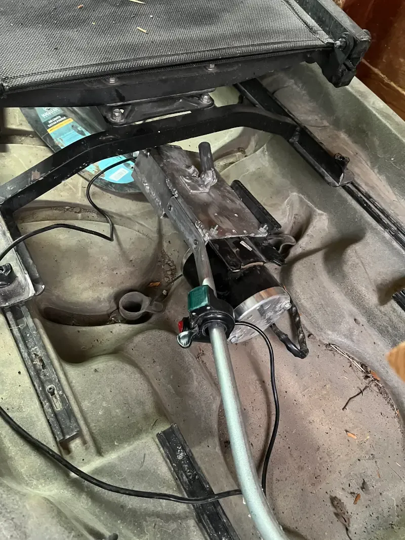 Homemade electric mud motor placed in the bottom of a hunting kayak for transporation.