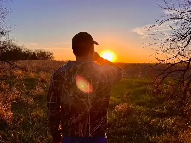Looking over shoulder into a field at sundown. Evening is a good time to scout for turkeys