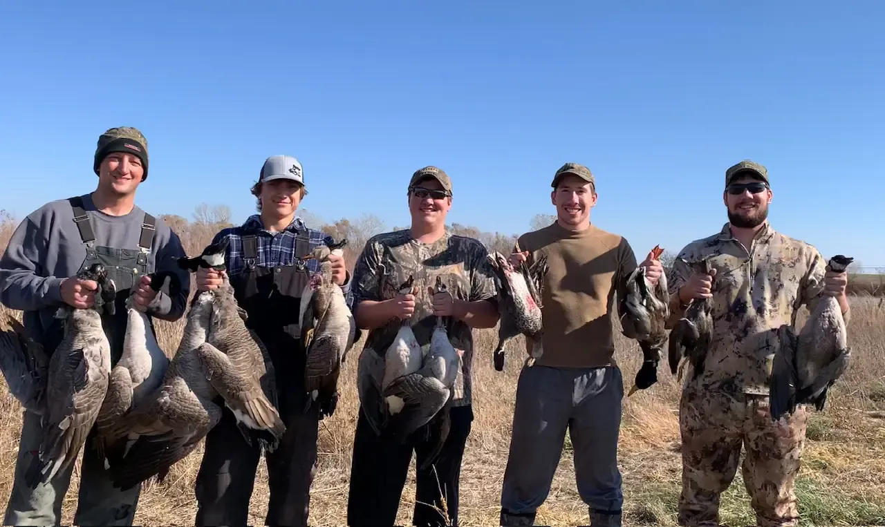 A group of hunters after a successful waterfowl hunt.